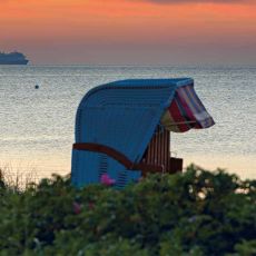 Beach chair with water and cruise ship in the background