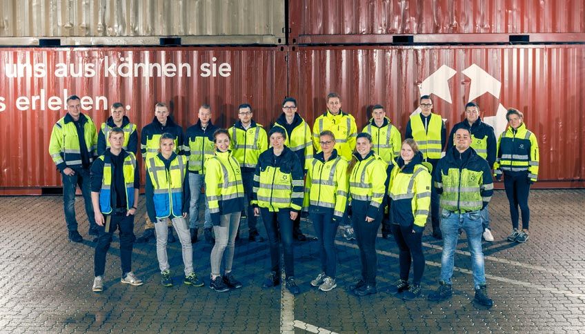 Employees of the PORT OF KIEL in front of containers